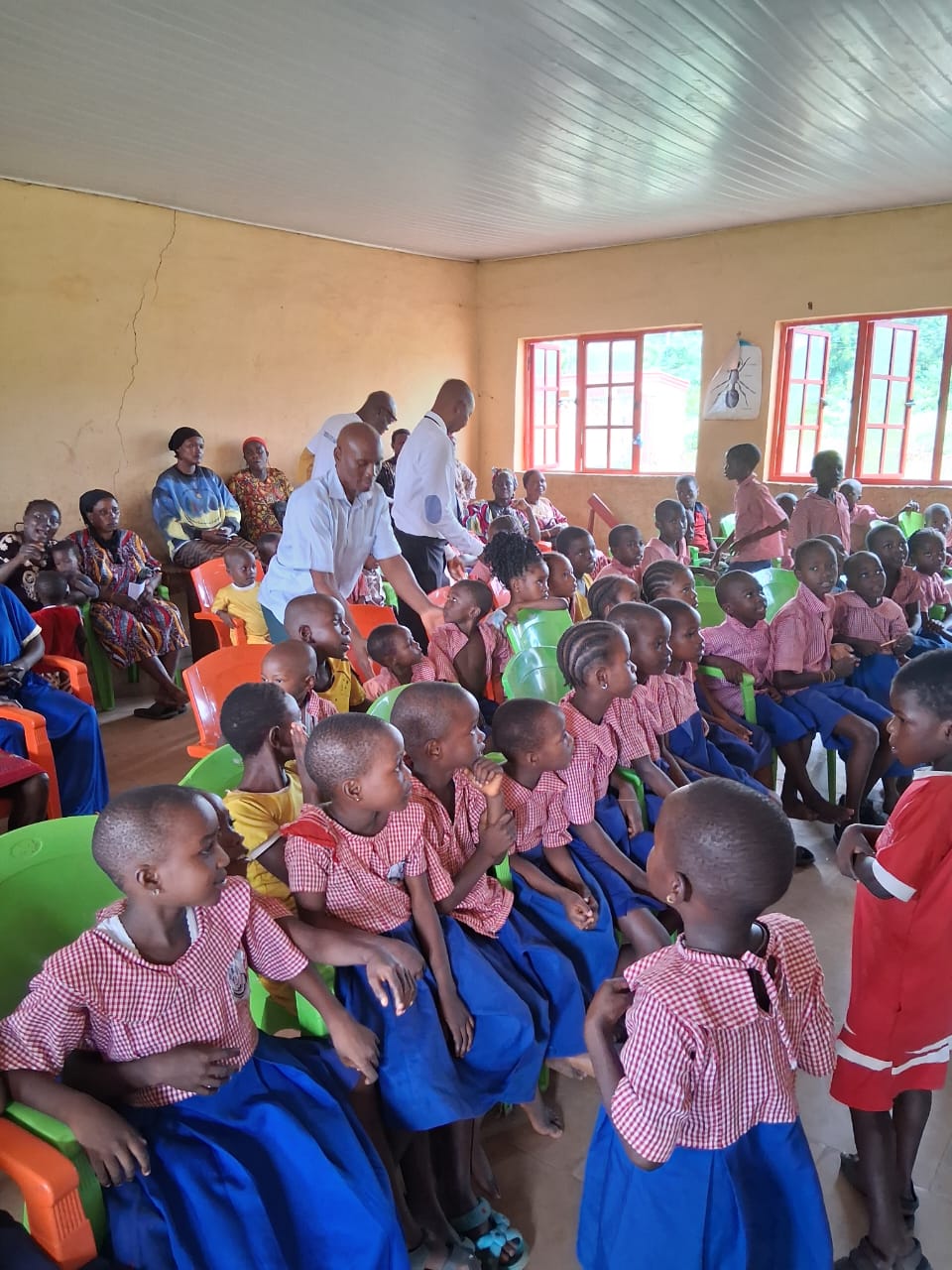 Pupils in red and blue uniforms seated in a classroom for the Back to School event
