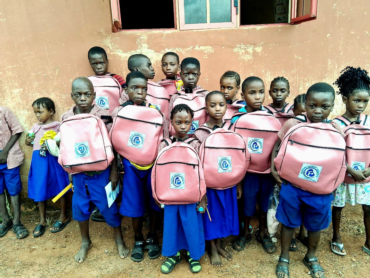 A group of pupils standing together with their new pink BBSI branded backpacks