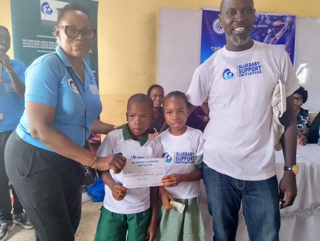 BBSI presenting a scholarship cheque to two pupils